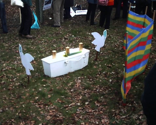 White coffin between two peace doves