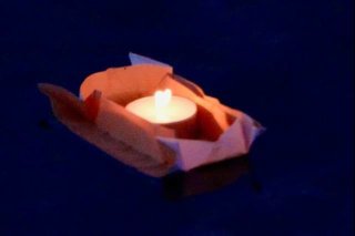 Origami boat with candle